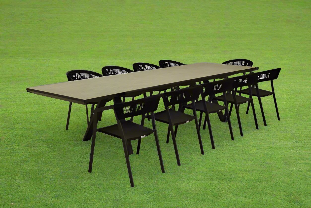 Rope outdoor dining set with eight rope chairs and a ceramic dining table, arranged on a grass field—ideal for stylish and comfortable outdoor gatherings.