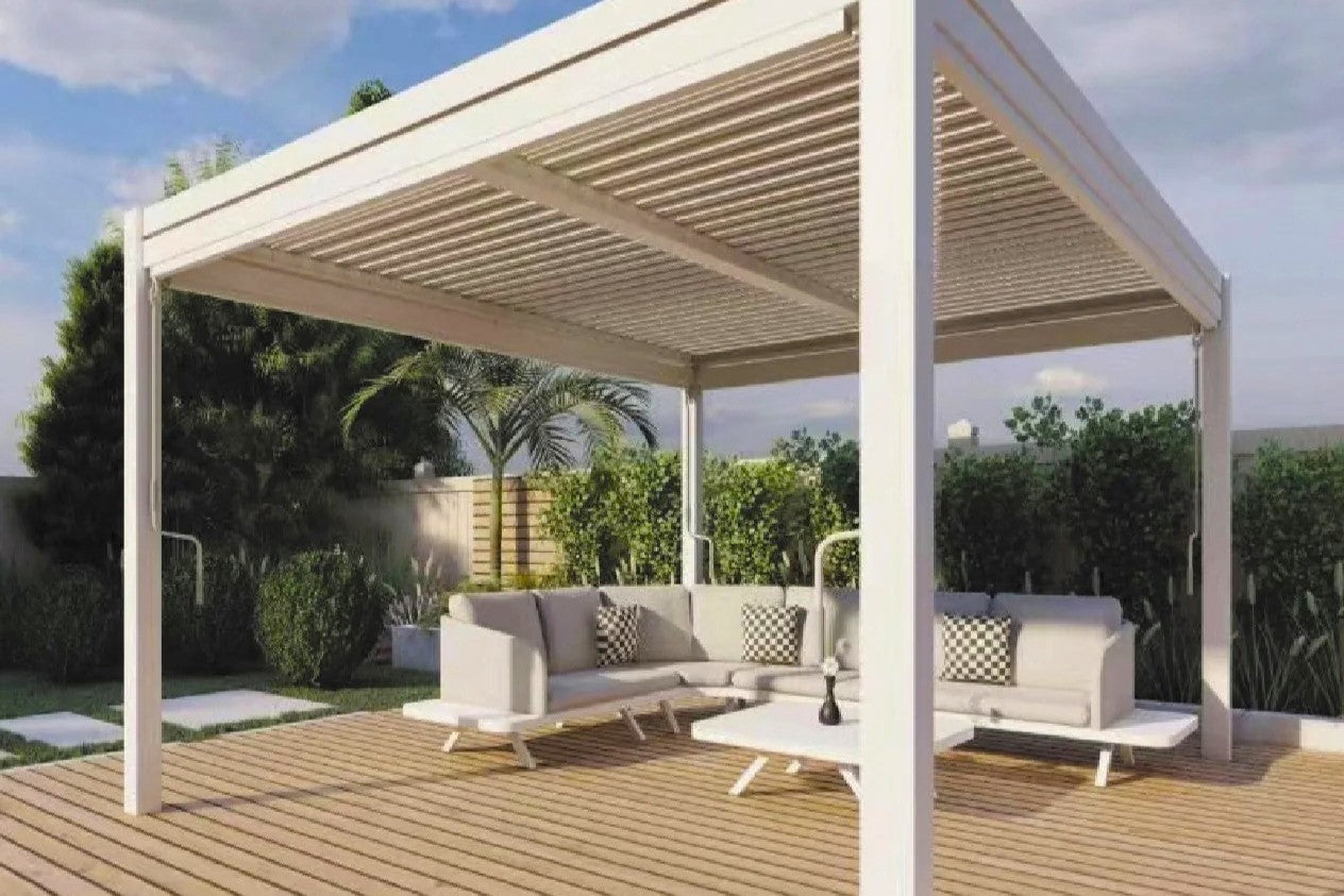 Modern white pergola with an outdoor lounge set on a wooden deck in an Australian backyard, surrounded by greenery.