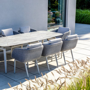 Sorrento Outdoor Aluminium Dining Table setup featuring the Sorrento Dining Chair by Couture Jardin, crafted with woven Olaphen rope and paired with a sleek dining table featuring a ceramic top. The chairs highlight their stylish curved design and comfortable cushions, creating a sophisticated and durable setting for patio or garden spaces.