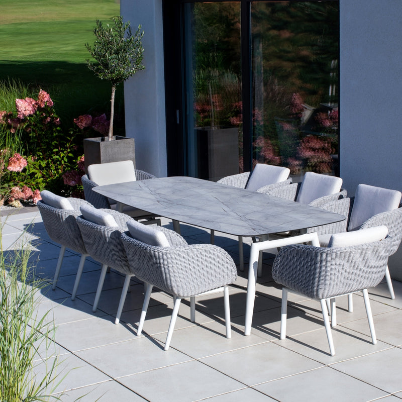 Sorrento Outdoor Aluminium Dining Table setup featuring the Sorrento Dining Chair by Couture Jardin, crafted with woven Olaphen rope and paired with a sleek dining table featuring a ceramic top. The chairs highlight their stylish curved design and comfortable cushions, creating a sophisticated and durable setting for patio or garden spaces.