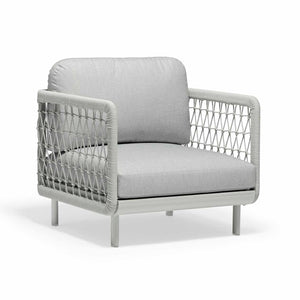 A sleek, light grey, upholstered outdoor armchair with an aluminium & rope frame, set against a plain white background.